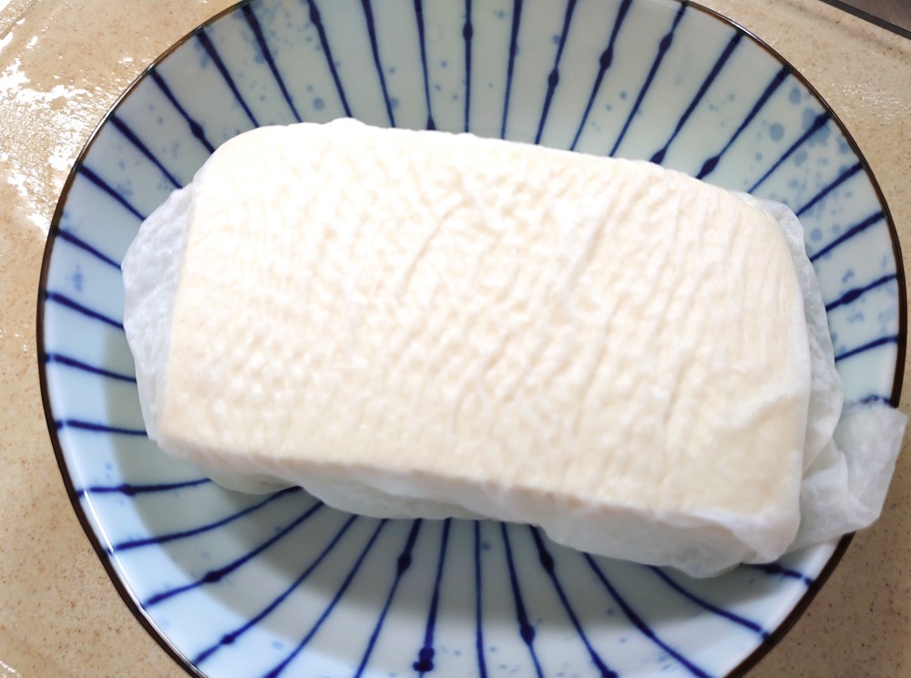 木綿豆腐をキッチンペーパーで包み、レンジ600wで1分加熱する。2cm角のさいの目切りにする。