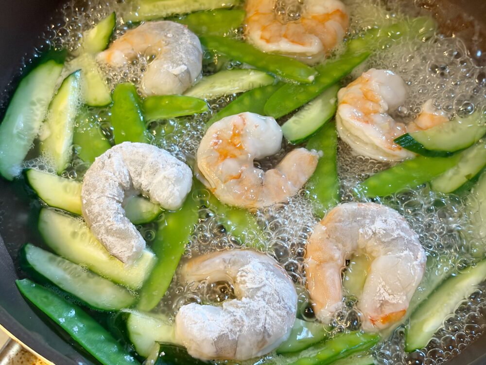 フライパンに水と調味料を入れて、煮立ったらすぐにえびを加える。えびが赤くなってきたら、返していく。